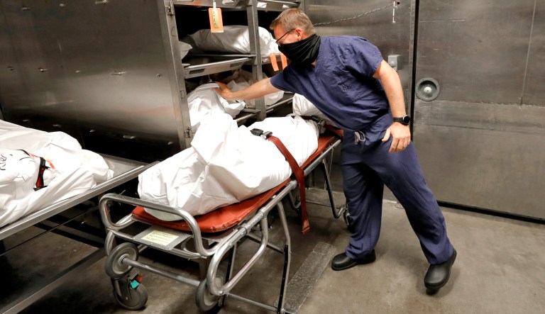 Pima County Medical Examiner Dr. Greg Hess inspects a body bag tag in Tuscon, Arizona.