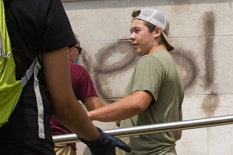 Kyle Rittenhouse helps clean the exterior of Reuther Central High School in Kenosha, Wis., on Tuesday, Aug. 25, 2020. Rittenhouse, 17, was arrested Wednesday, Aug. 26, after two people were shot to death during protests in Kenosha over the police shooting of Jacob Blake. 