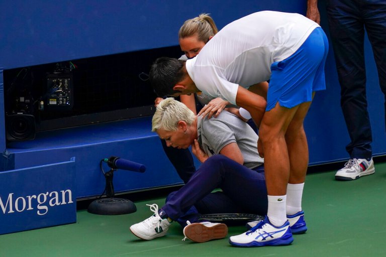 Novak Djokovic, of Serbia, checks a linesman after hitting her with a ball.