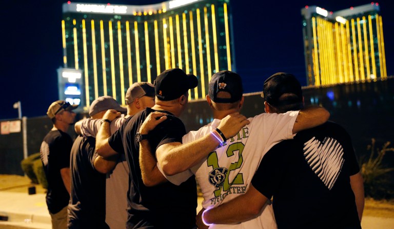 FILE - In this Oct. 1, 2018, file photo, survivors return to the scene of a mass shooting on the first anniversary in Las Vegas. A judge in Nevada has approved a total of $800 million in payouts from casino company MGM Resorts International and its insurers to more than 4,400 relatives and victims of the Las Vegas Strip shooting that was the deadliest in recent U.S. history. 