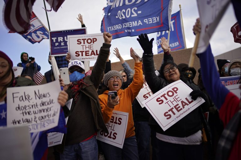 Supporters of President Donald Trump pray as they protest the election outside of the Clark County Election Department, Sunday, Nov. 8, 2020, in North Las Vegas.