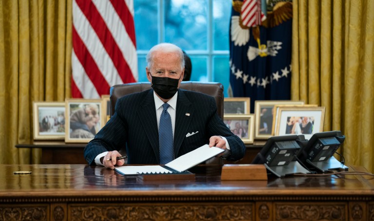President Joe Biden looks up after singing an Executive Order reversing the Trump era ban on transgender personnel serving in military, in the Oval Office of the White House.
