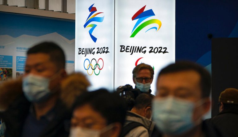 Attendees wearing face masks to protect against the spread of the coronavirus look at an exhibit at a visitors center at the Winter Olympic venues in Yanqing on the outskirts of Beijing, Friday, Feb. 5, 2021. 