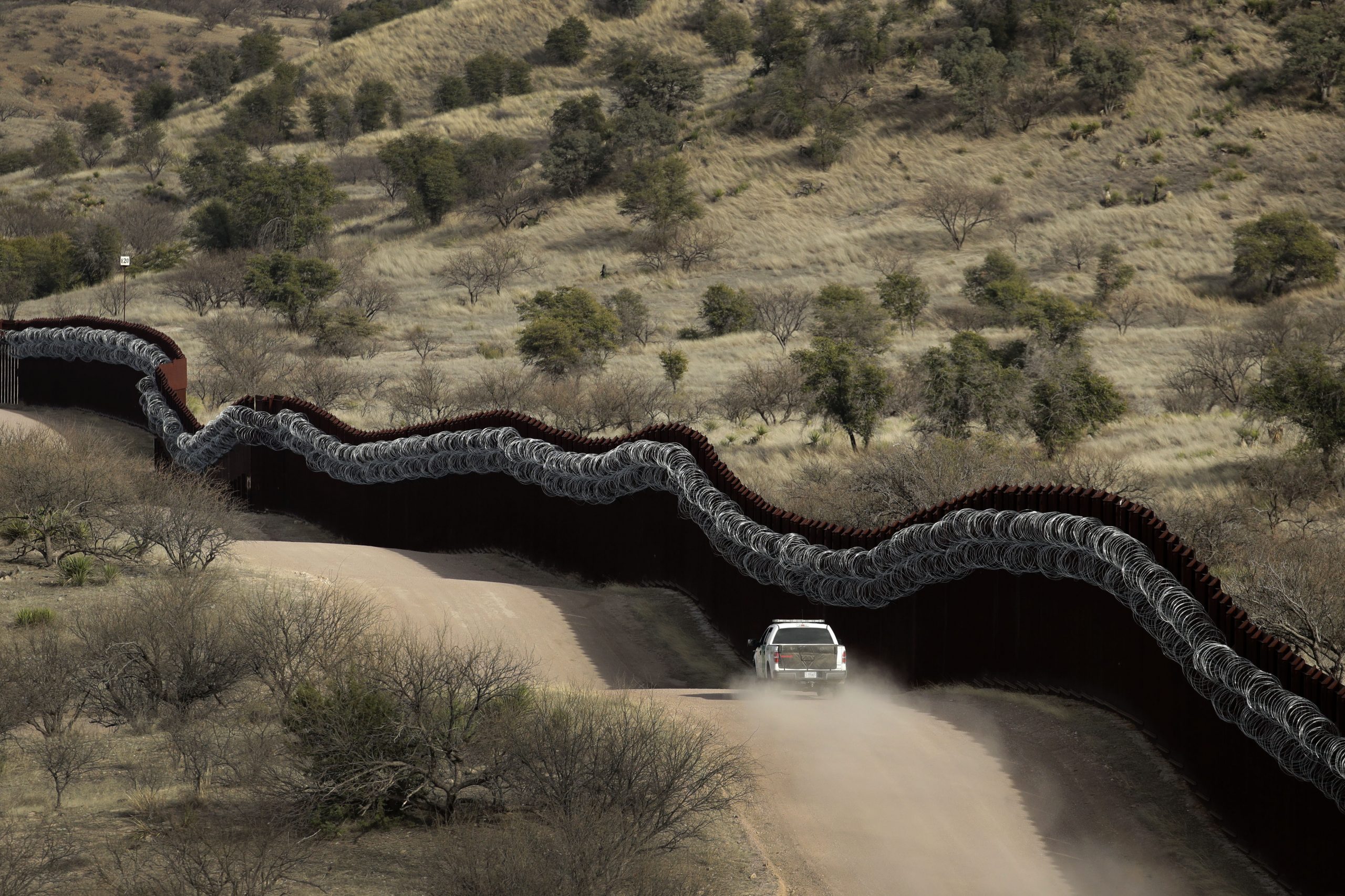 Border Patrol video shows smugglers drop two young girls over 14-foot barrier