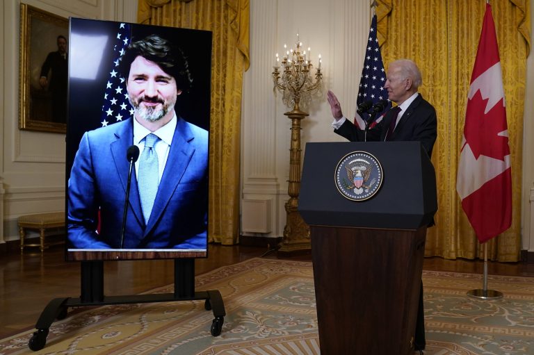 President Joe Biden waves after holding a virtual meeting with Canadian Prime Minister Justin Trudeau, in the East Room of the White House Tuesday