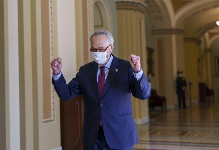 Senate Majority Leader Chuck Schumer, D-N.Y., leaves the chamber just after the Senate narrowly approved a $1.9 trillion COVID-19 relief bill, at the Capitol in Washington, Saturday.