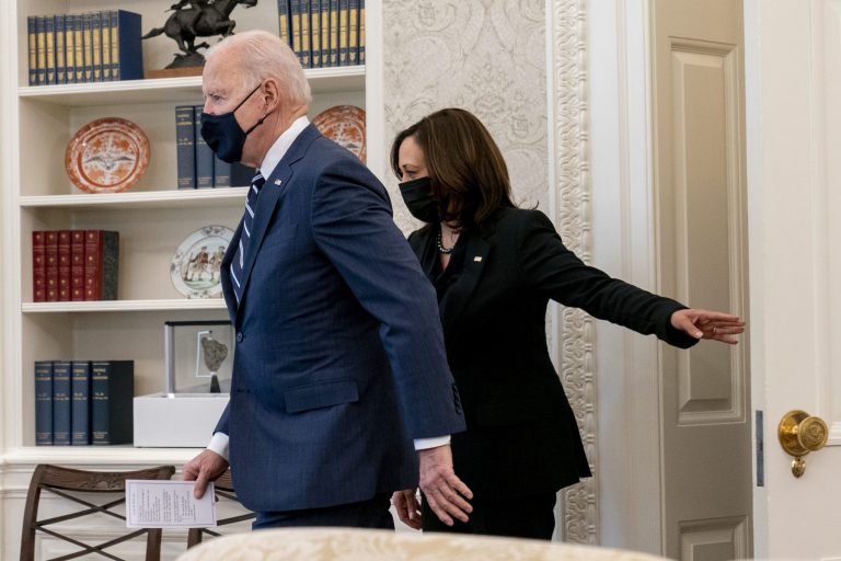President Joe Biden, accompanied by Vice President Kamala Harris, arrives to sign the American Rescue Plan, a coronavirus relief package, in the Oval Office of the White House, on March 11.