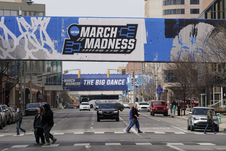March Madness banners for the NCAA college basketball tournament cover crosswalks in downtown Indianapolis, Wednesday, March 17, 2021. 