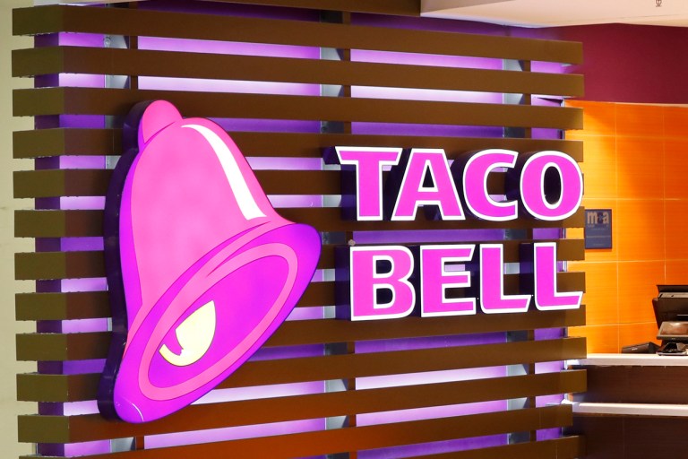 FILE - This Friday, April 19, 2019 photo shows a Taco Bell logo at a restaurant in Miami. Taco Bell announced June 28 it is testing two new products that both feature giant Cheese-It crackers. (AP Photo/Wilfredo Lee)