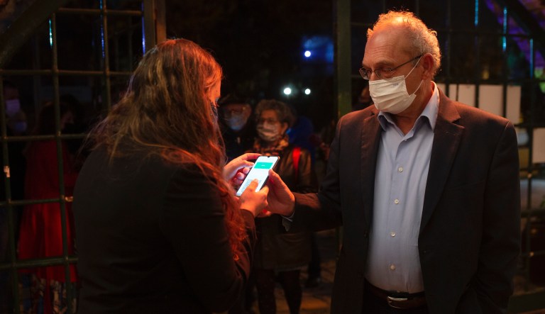 In this Tuesday, Feb. 23, 2021, file photo, a man presents his "green passport," proof that he is vaccinated against the coronavirus, on opening night at the Khan Theater for a performance where all guests were required to show proof of vaccination or full recovery from the virus, in Jerusalem. Vaccine passports are being developed in the U.S. to verify COVID-19 immunization status and allow inoculated people to more freely travel, shop and dine.