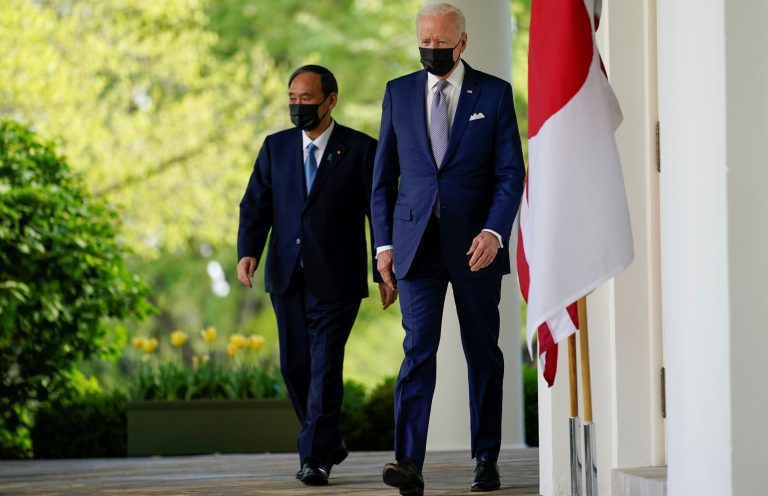 President Joe Biden, accompanied by Japanese Prime Minister Yoshihide Suga, walks from the Oval Office to speak at a news conference in the Rose Garden of the White House, Friday, April 16, 2021, in Washington. 