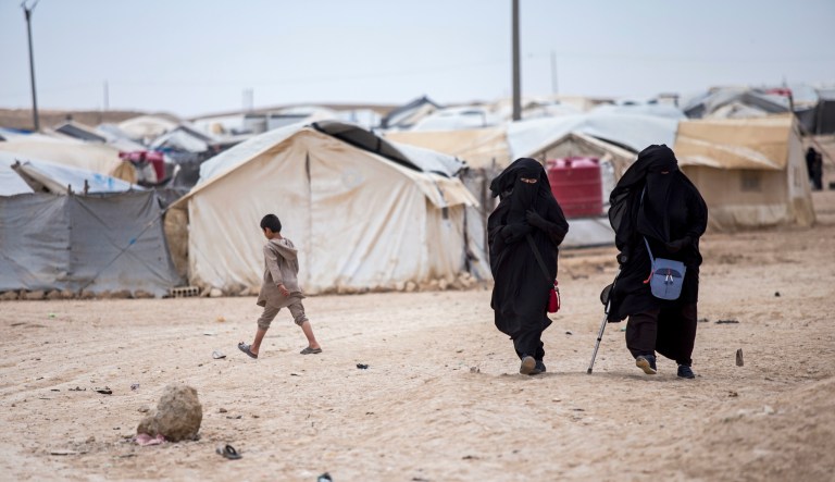 Women walk at al-Hol camp, home to some 60,000 people, many of them families and supporters of Islamic State fighters, in Hasakeh province, Syria, Saturday, May 1, 2021. Security inside al-Hol camp has improved since a security operation was carried out last month but concern over a coronavirus outbreak in the crowded facility has grown.