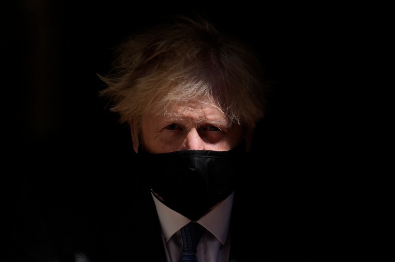 Britain's Prime Minister Boris Johnson, wearing a face mask, visits the headquarters of the London Ambulance Service NHS Trust in London, Monday July 13, 2020.