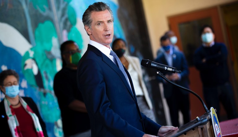 In this Aug. 11, 2021, file photo, California Gov. Gavin Newsom speaks with reporters at Carl B. Munck Elementary School in Oakland, Calif. Newsom has sharpened his message in the recall's final month and is focusing his attention on conservative rival Larry Elder, who has pledged to end California's mask mandate. The last day to vote is Sept. 14.