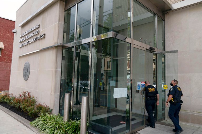 A Homeland Security police officers enter the U.S. District Courthouse were Jonathan and Diana Toebbe have their hearing in Martinsburg, W.Va., on Tuesday, Oct. 12, 2021. Jonathan Toebbe, a Navy nuclear engineer, has been charged with trying to pass information about the design of American nuclear-powered submarines to someone he thought was a representative of a foreign government but who turned out to be an undercover FBI agent. His wife also was arrested. 