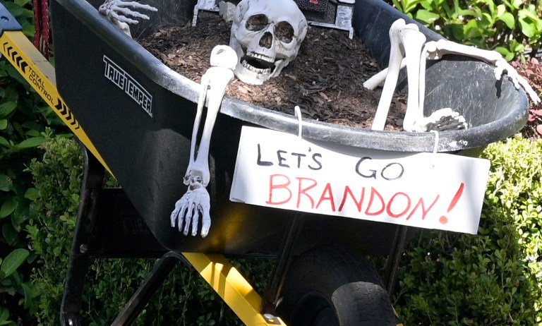A Halloween display incorporating a Make America Great Again hat, a Creepy Joe headstone and a Let's Go Brandon sign is viewed outside a home during a new coronavirus pandemic, Wednesday, Oct. 27, 2021, in Orlando, Fla. 