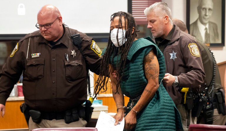 Darrell Brooks, center, is escorted out of the courtroom after making his initial appearance, Tuesday, Nov. 23, 2021 in Waukesha County Court in Waukesha, Wisconsin.
