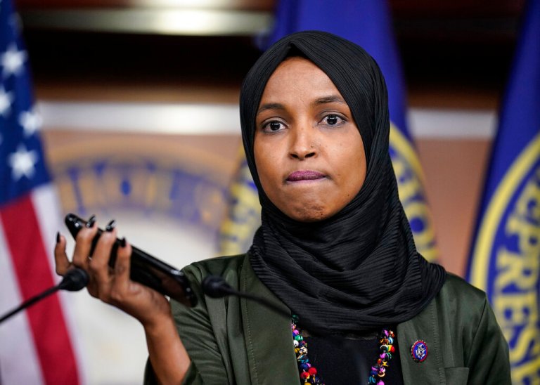 Rep. Ilhan Omar, D-Minn., plays a recording of a death threat left on her voicemail in the wake of anti-Islamic comments made last week by Rep. Lauren Boebert, R-Colo., who likened Omar to a bomb-carrying terrorist, during a news conference at the Capitol in Washington, Tuesday, Nov. 30, 2021. 