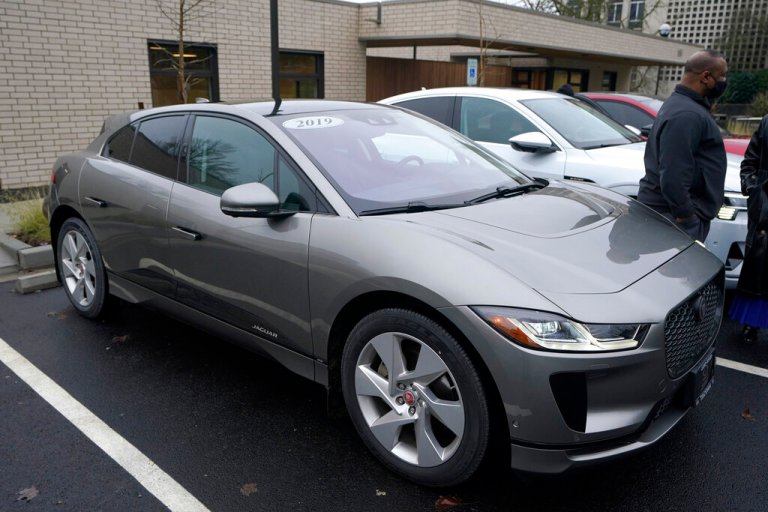 A Jaguar I-Pace EV400 electric vehicle is shown Monday, Dec. 13, 2021, following a news conference in Olympia, Wash. where Gov. Jay Inslee announced several climate-related proposals for the 2022 legislative session, including a plan to offer rebates on the purchase of new and used electric vehicles for qualified buyers. 