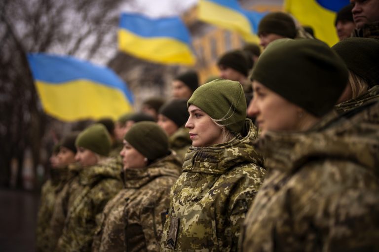 Ukrainian Army soldiers pose for a photo as they gather to celebrate a Day of Unity in Odesa, Ukraine, Wednesday, Feb. 16, 2022. 