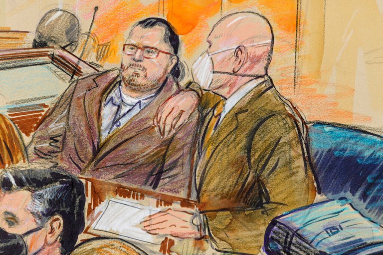 This artist sketch depicts Guy Wesley Reffitt, joined by his lawyer William Welch, right, in Federal Court, in Washington, on Feb. 28, 2022.