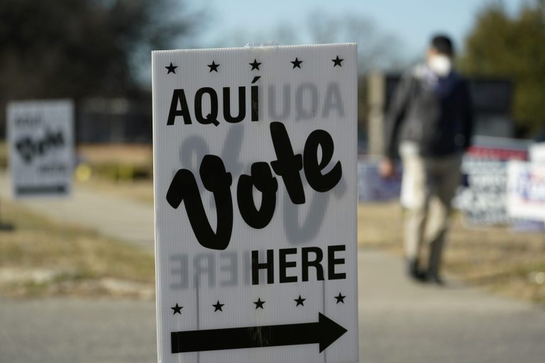A man passes an early voting poll site on Feb. 14 in San Antonio, Texas. 