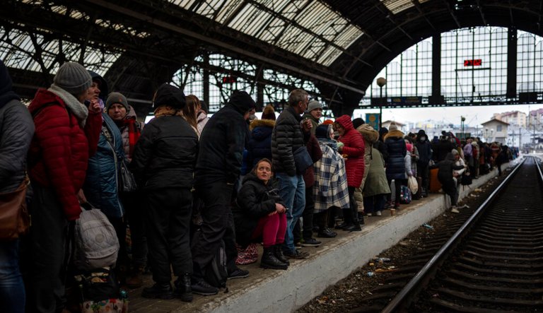 Passengers wait at the platform inside a railway station on Feb. 27, 2022, in Lviv, Ukraine. The city has been a refuge since the war began nearly a month ago, the last outpost before Poland and host to hundreds of thousands of Ukrainians streaming through or staying on. 