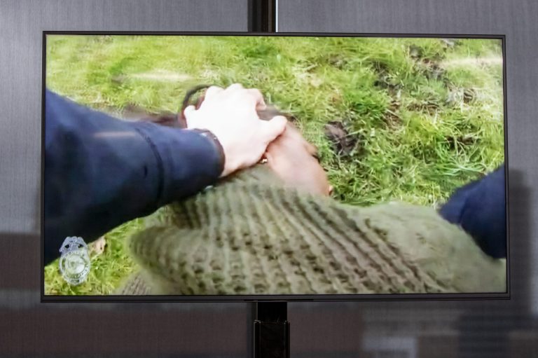 A TV display shows video evidence of a Grand Rapids police officer struggling with and shooting Patrick Lyoya at Grand Rapids City Hall on Wednesday, April 13, 2022.