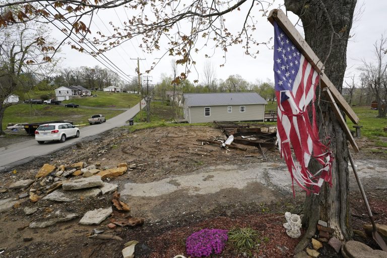 A flag hangs near the remains of a home destroyed in a Dec. 10 tornado on April 21, 2022, in Dawson Springs, Kentucky.