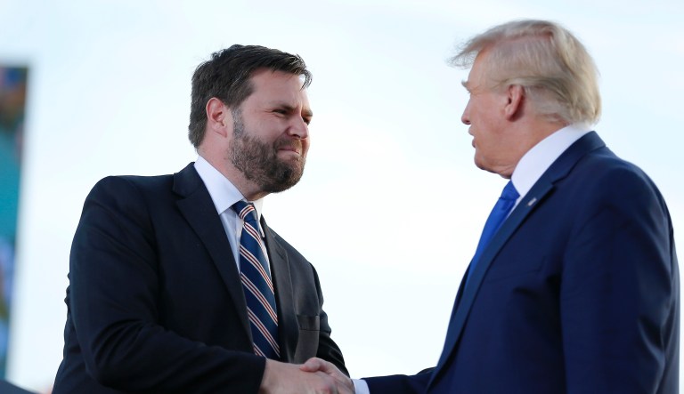 Senate candidate JD Vance, left, greets former President Donald Trump at a rally.