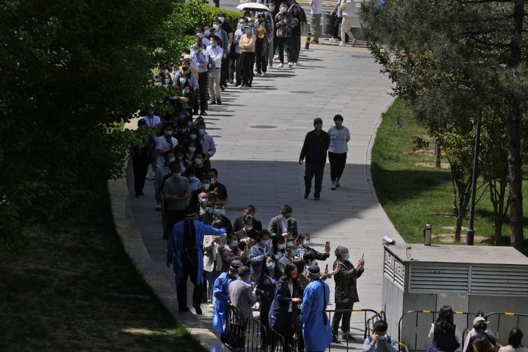 Residents line up for COVID mass testing near tents set up at a plaza in the Haidian district on Tuesday, April 26, 2022, in Beijing. China's capital Beijing is enforcing mass testing and closing down access to neighborhoods as it seeks to contain a new COVID-19 outbreak. 