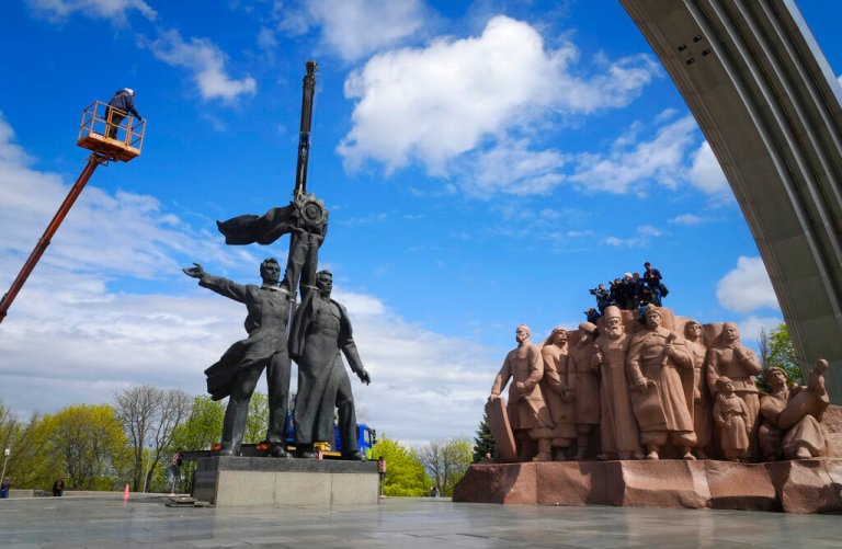 A Soviet era monument to a friendship between Ukrainian and Russian nations is seen during its demolition, amid Russia's invasion of Ukraine, in central Kyiv, Ukraine, Tuesday, April 26, 2022.