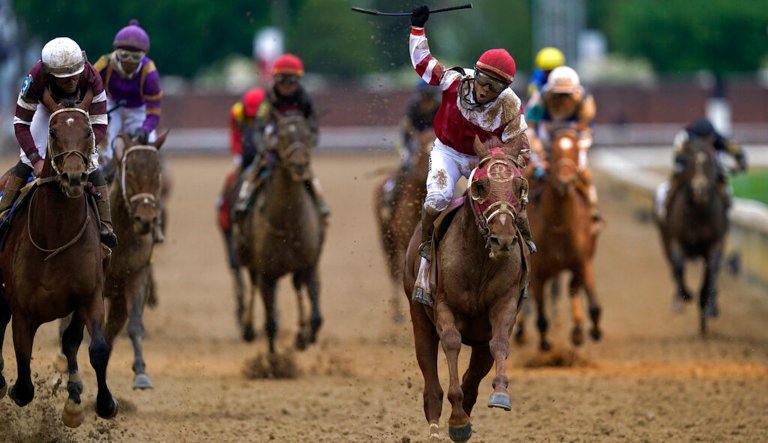 Sonny Leon celebrates after riding Rich Strike past the finish line to win the 148th running of the Kentucky Derby at Churchill Downs Saturday, May 7, 2022, in Louisville. 