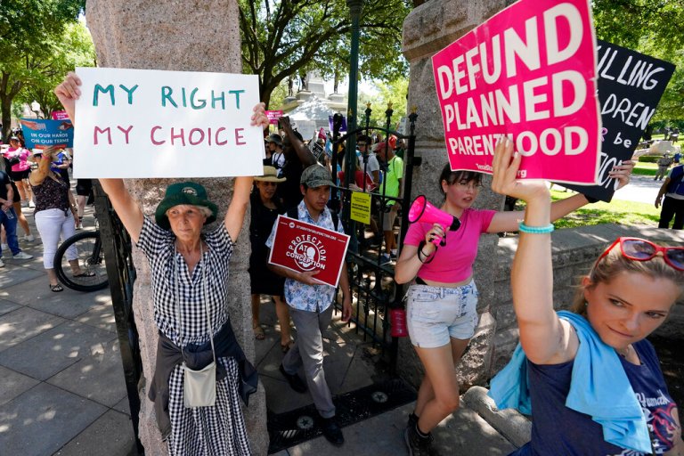 Anti-abortion demonstrators pass by abortion rights demonstrators at a rally at the Texas Capitol, Saturday, May 14, 2022, in Austin, Texas.