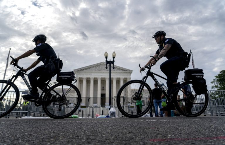 U.S Police officers patrol on bicycles past the U.S. Supreme Court building in Washington.