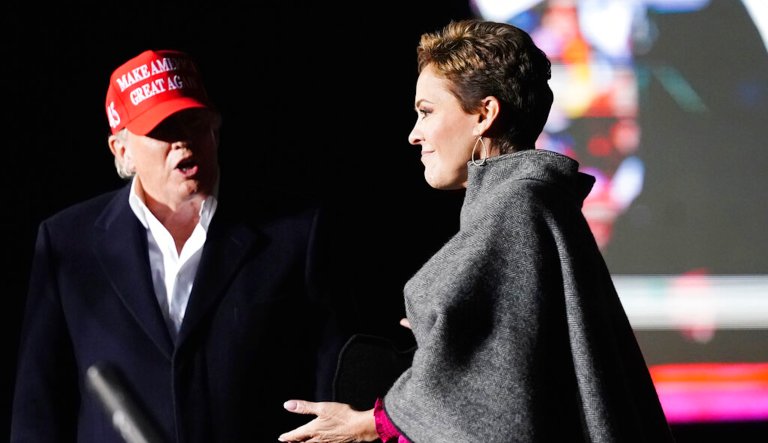 Former President Donald Trump (left) introduces Arizona Republican candidate for governor Kari Lake (right) as he speaks at a rally on Jan. 15, 2022, in Florence, Arizona.