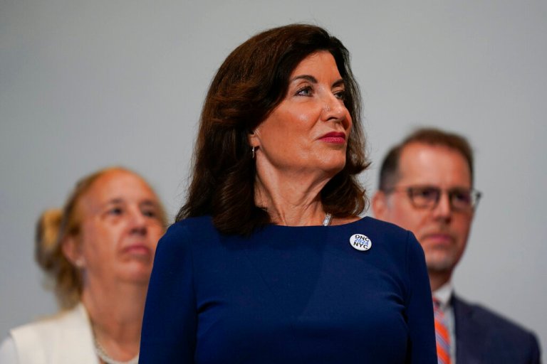 New York Gov. Kathy Hochul listens to speakers during a news conference in New York.