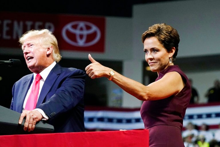 Arizona Republican candidate for governor, Kari Lake, gives a thumbs up to the crows as former President Donald Trump speaks at a Save America rally Friday, July 22, 2022, in Prescott, Ariz.