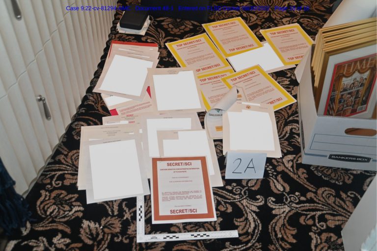 Documents seized during the Aug. 8 search by the FBI of former President Donald Trump's Mar-a-Lago estate are displayed across the floor.