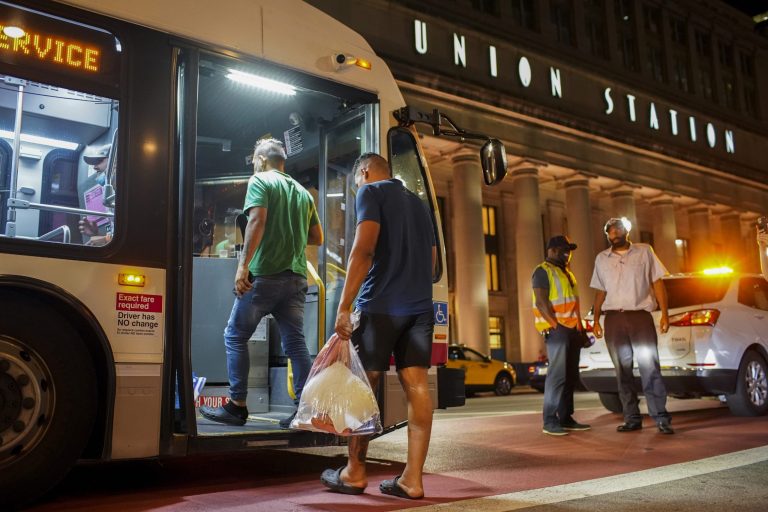 People board a Chicago Transit Authority bus after arriving with other immigrants from Texas at Union Station in Chicago. 