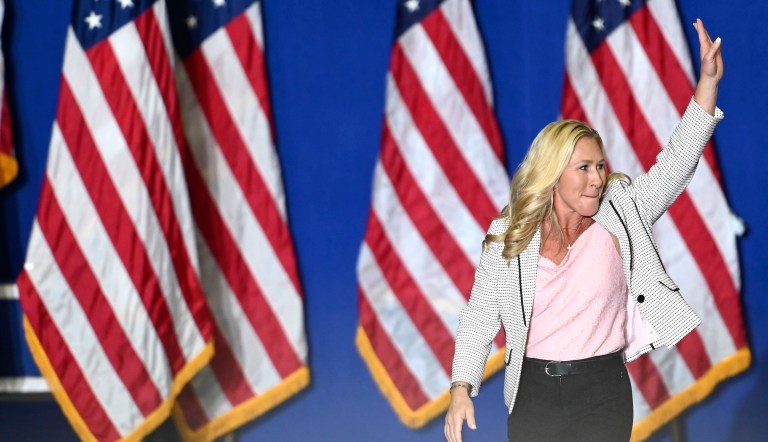 U.S. Congresswoman Marjorie Taylor Greene waves on her way to the podium at a Donald Trump rally at Macomb Community College Sports & Expo Center in Warren, Saturday, Oct. 1, 2022.