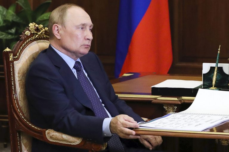 Russian President Vladimir Putin listens during a meeting.
