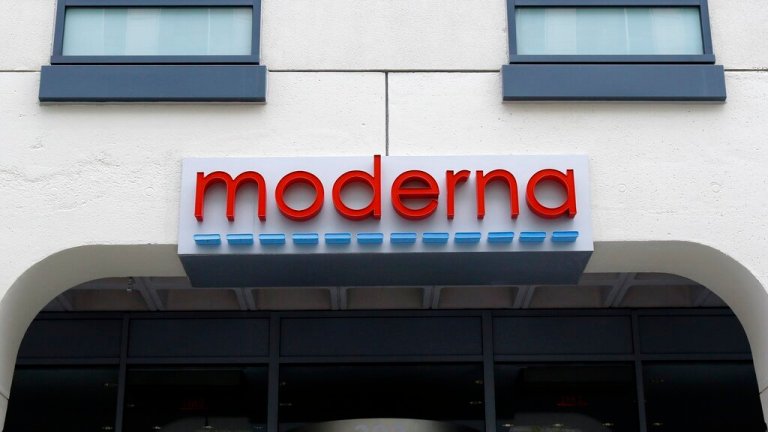 A sign marks an entrance to a Moderna building in Cambridge, Mass., on Monday, May 18, 2020.  Shares of Merck and Moderna jumped early Tuesday, Dec. 13, 2022,  after the drugmakers said a potential skin cancer vaccine they are developing using the same technology behind COVID-19 preventive shots did well in a mid-stage study. 