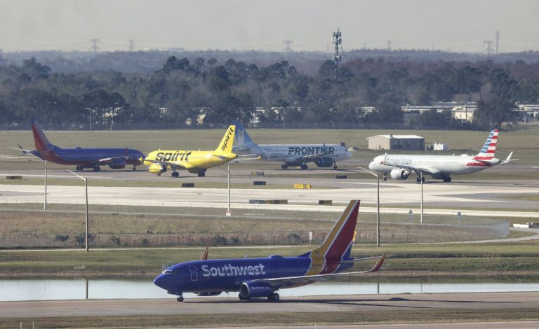 Planes wait for takeoff in a queue at Orlando International Airport, Wednesday, Jan. 11, 2023, after the FAA grounded all U.S. flights earlier in the day. 