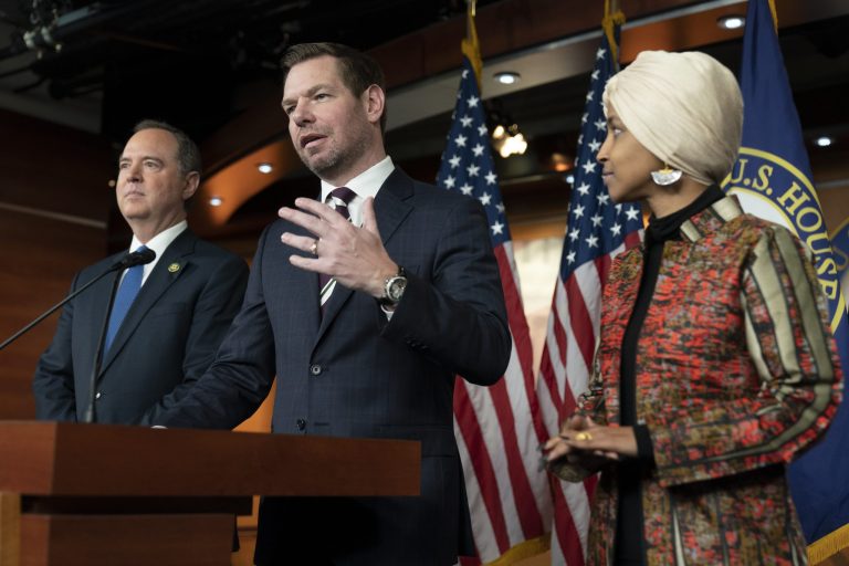 Rep. Eric Swalwell (D-CA), center, with Rep. Adam Schiff (D-CA), left, and Rep. Ilhan Omar (D-MN), speaks during a news conference on Capitol Hill in Washington, Wednesday, Jan. 25, 2023, in Washington. 