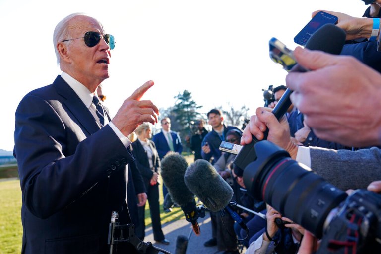 President Joe Biden talks with reporters on the South Lawn of the White House in Washington, Monday, Jan. 30, 2023, after returning from an event in Baltimore on infrastructure. 