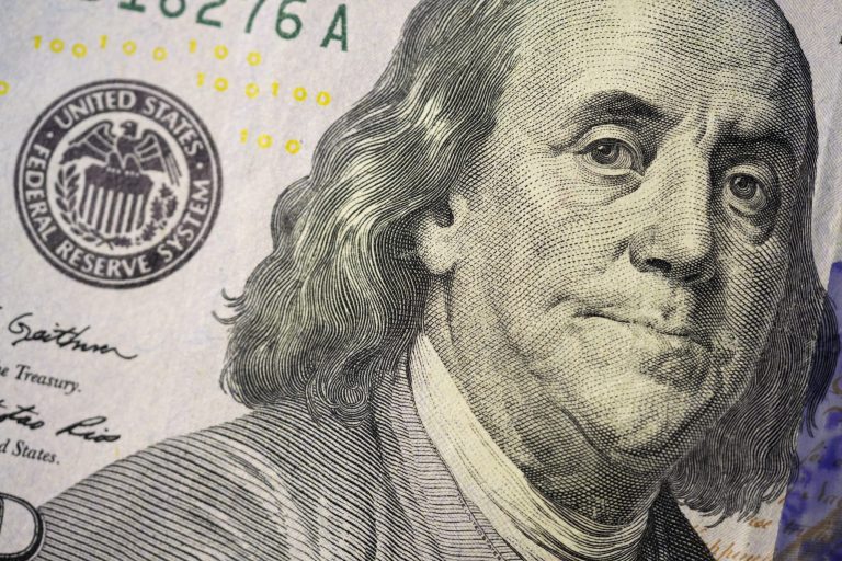 The likeness of Benjamin Franklin is seen on a U.S. $100 bill, Wednesday, Feb. 22, 2023, in Marple Township, Pennsylvania. (AP Photo/Matt Slocum)