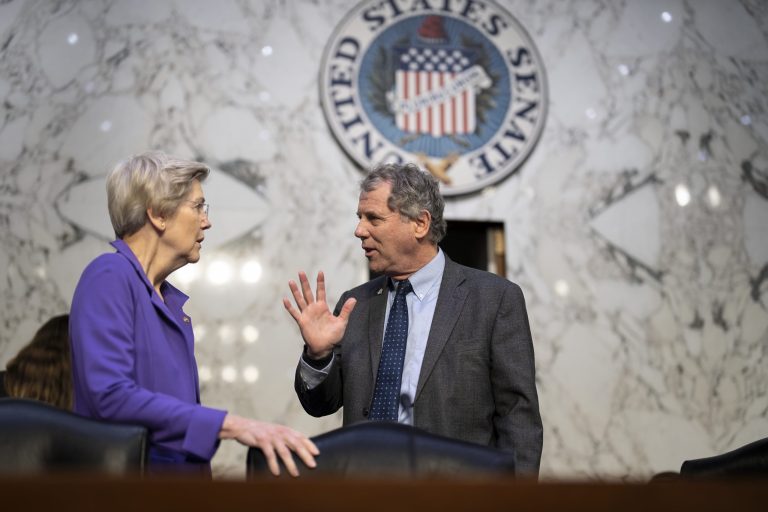 Chairman Sherrod Brown speaks with Sen. Elizabeth Warren, left, just before Federal Reserve Board Chairman Jerome Powell delivers his semiannual Monetary Policy Report to the Senate Banking, Housing, and Urban Affairs Committee, at the Capitol in Washington, Tuesday, March 7, 2023. 
