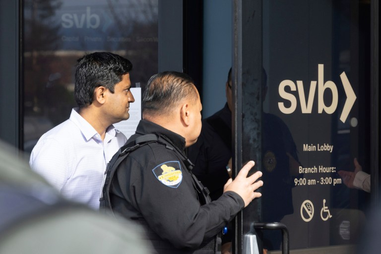 A customer exits Silicon Valley Bank's headquarters in Santa Clara, Calif., on Monday, March 13, 2023. The federal government intervened Sunday to secure funds for depositors to withdraw from Silicon Valley Bank after the bank's collapse. Dozens of individuals waited in line outside the bank to withdraw funds. 