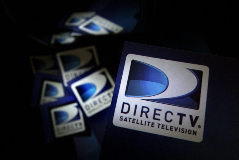 DirecTV logos are seen on flyers in North Andover, Mass., Aug. 6, 2009. Newsmax is returning to DirecTV after a dispute between the parties saw the conservative network removed from the satellite carrier. The companies said Wednesday, March 22, 2023, that they have now reached a multi-year distribution deal that will see the Newsmax channel return to DirecTV, DirecTV Stream and U-verse starting Thursday, March 23.